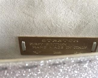 GOLD AND SILVER SPARKLY GLITTER CLUTCH
Condition: Pristine
Grey suede lining. Single wall pocket at interior. Fold-in flap closure at front flap
Dimensions: Width: 12". Height: 5"