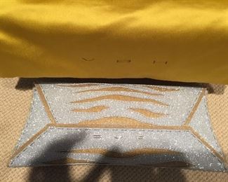 GOLD AND SILVER SPARKLY GLITTER CLUTCH
Condition: Pristine
Grey suede lining. Single wall pocket at interior. Fold-in flap closure at front flap
Dimensions: Width: 12". Height: 5"
