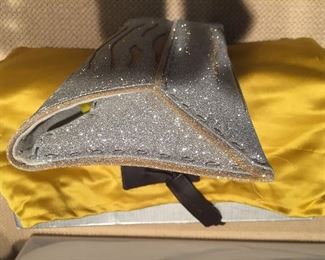 GOLD AND SILVER SPARKLY GLITTER CLUTCH
Condition: Pristine
Grey suede lining. Single wall pocket at interior. Fold-in flap closure at front flap
Dimensions: Width: 12". Height: 5"