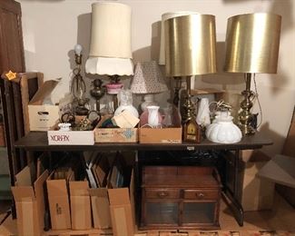 lots of lamps and lamp parts including Stiffel, oil lamps, milk glass globes, brass lamps - framed art work - also another petite antique wall curio with glass doors 
