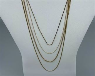 Four Gold Tone Necklaces and Others