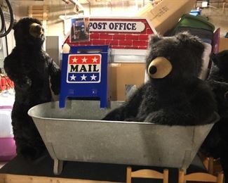 Many large stuffed bears and other animals to be sold; large metal bathtub; large post office display.