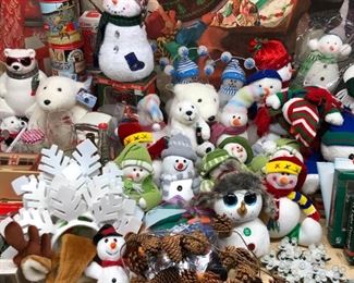 Many bear and snowman stuffed toys and figurines.