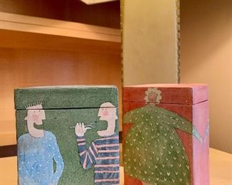 Item 93:  Whimsical ceramic rectangular lidded vessels by Reina:                                                                       
Green with Two Men - 5.75": $40                                                                                  Orange with Green Dress - 5.75": $40