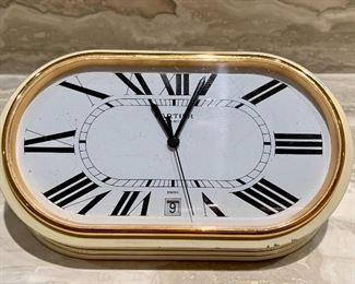 Item 155:  Cartier quartz desk clock with date, oval face with Roman numerals in enameled case - 5.5" x 2.5": $225 