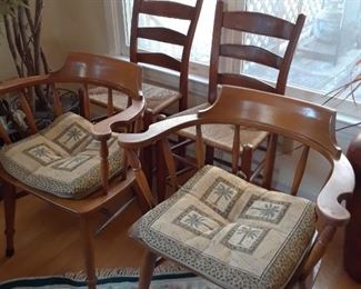 Pair of captain's chairs in foreground; ladderbacks in background