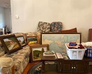 Coffee table, sectional sofa, framed world map, original paintings, rugs and seat cushions. 