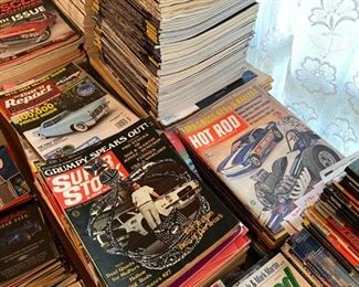 Stacks of collectible hot rod, racing, NHRA magazines.