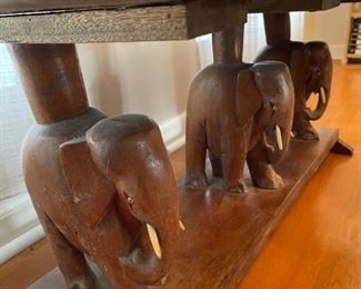 Coffee table with hand-carved elephant top and base. 