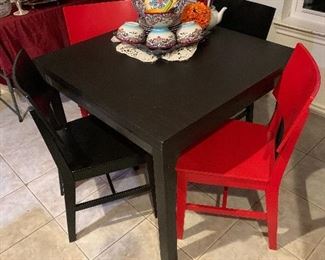 $325 BLACK EXTENSION TABLE AND FOUR CHAIRS 