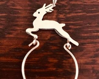 14k yellow gold reindeer charm holder, measuring 2" tall, and weighing 1.1g.  $98