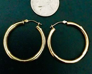 14k yellow gold hoop earrings, measuring 1 1/8" in diameter, and weighing 1.9g.   $248