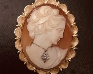 14k yellow gold antique carved shell cameo with diamond.  It is 1 1/2" tall by 1 1/4" wide, and weighs 6.8g.  $488