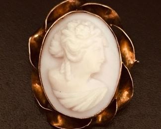 10k yellow gold vintage cameo pin or pendant, measuring 1" by 7/8", weighing 3.5g.  $148