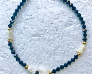 14k yellow gold, carved mother of pearl, and black onyx bracelet measuring 8 1/8" long.  $98
