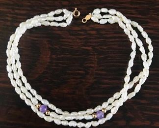 14k yellow gold, freshwater pearls, and amethyst triple strand bracelet, measuring 8" long.  $98