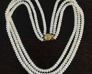 Triple strand freshwater pearls with 14k yellow gold clasp. 18 to 19 inches long.  Marked 14k.  $240