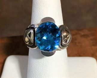 John Atencio ring in 18k yellow gold and sterling silver with a stunning genuine blue topaz. Size 6 1/2. Face of ring is 3/4" wide by 5/8" high. Signed with a conjoined JA, stamped 18K SS. $680