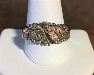 10k yellow and rose gold and sterling silver Landstrom's Black Hills Gold ring size 12. Face of ring is 7/8" wide by 3/8" high. Signed, stamped STER + 10K. $350 