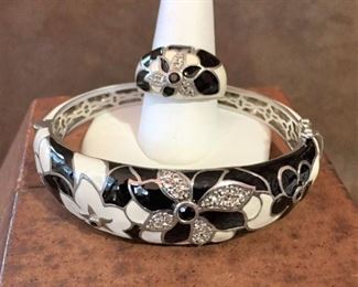 Sterling silver and enamel hinged bracelet and dome ring, each with black and clear faceted crystal accents in the flowers. Ring size 9. Bracelet inner circumference is 6 7/8". Sliding box clasp with safety latch on each side of the clasp. Each is signed EMA and stamped 925. Bracelet $140, Ring $60