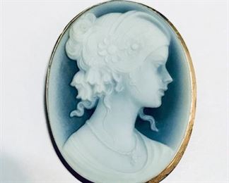 14k yellow gold framed blue cameo pin or pendant, measuring 1 5/8" tall by 1 1/8" wide, and weighing 6.6g.  $240
