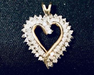 10k yellow gold and diamond heart pendant, measuring 1" tall by 3/4" wide, weighing 3.2g.  $440