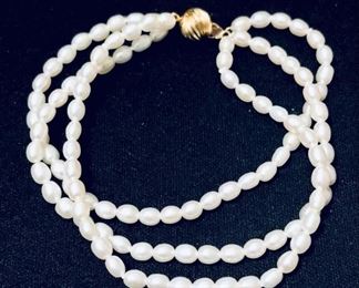 14k gold ball clasp and triple strand freshwater pearls.  7.5" long when clasped.  $120