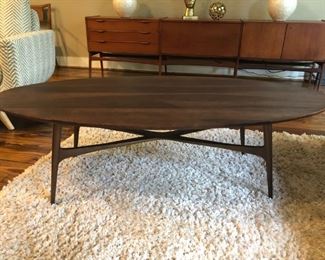 Modernist oval coffee table on bronze finish metal base, 18” high x 58” long x 28” wide