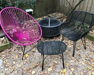 All-weather patio furniture including pink vinyl Acapulco chair and fire pit/brazier