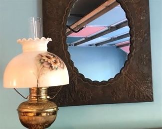 Embossed tin wall mirror and vintage brass table lamp with hand-painted glass shade