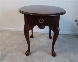oval cherry colored  end or lamp table    21 x  25    table  is  45.00
