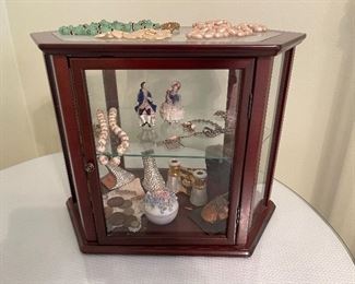 8. Small tabletop curio with jewelry and figureines inside as well as a pair of mother of pearl opera glasses binoculars. Some antique foreign coins as well.    One pin which is a marked piece of 14k Gold (shown with coins) $125 all