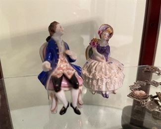 8. Small tabletop curio with jewelry and figureines inside as well as a pair of mother of pearl opera glasses binoculars. Some antique foreign coins as well.    One pin which is a marked piece of 14k Gold (shown with coins) $125 all