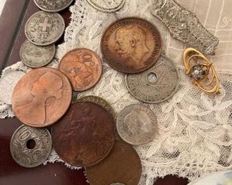 8. Small tabletop curio with jewelry and figureines inside as well as a pair of mother of pearl opera glasses binoculars. Some antique foreign coins as well.    One pin which is a marked piece of 14k Gold (shown with coins) $125 all
