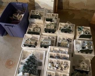 40. Hawthorne Village and Ashton Drake Christmas Village lot.  There a few Small accessory pieces in the blue tub.   Boxes leaning on wall are bases for ice skating rinks, etc.  The Christmas tree is awesome!  $195  all