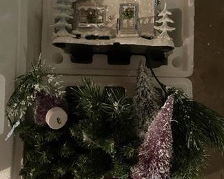 40. Hawthorne Village and Ashton Drake Christmas Village lot.  There a few Small accessory pieces in the blue tub.   Boxes leaning on wall are bases for ice skating rinks, etc.  The Christmas tree is awesome!  $195  all