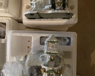 40. Hawthorne Village and Ashton Drake Christmas Village lot.  There a few Small accessory pieces in the blue tub.   Boxes leaning on wall are bases for ice skating rinks, etc.  The Christmas tree is awesome!  $195  all