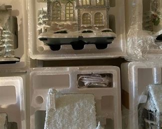 40. Hawthorne Village and Ashton Drake Christmas Village lot.  There a few Small accessory pieces in the blue tub.   Boxes leaning on wall are bases for ice skating rinks, etc.  The Christmas tree is awesome!  $195  all