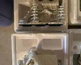 40. Hawthorne Village and Ashton Drake Christmas Village lot.  There a few Small accessory pieces in the blue tub.   Boxes leaning on wall are bases for ice skating rinks, etc.  The Christmas tree is awesome!  $195  all