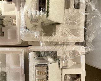 40. Hawthorne Village and Ashton Drake Christmas Village lot.  There a few Small accessory pieces in the blue tub.   Boxes leaning on wall are bases for ice skating rinks, etc.  The Christmas tree is awesome!  $195  all