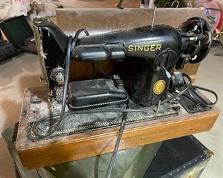 48. Singer Sewing machine with wood domed lid and 1 older black trunk, and metal file cabinet $55