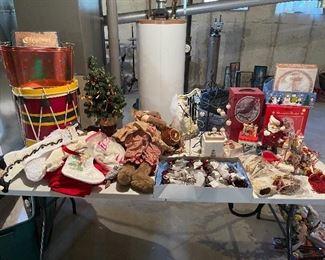 55. Table of christmas stuff including drum, stuffed stockings, bear, silverplate rose things, and more $60