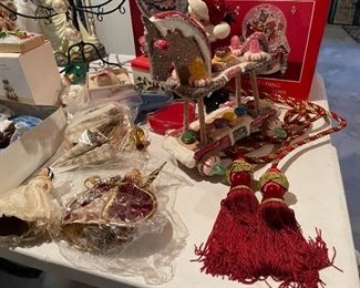 55. Table of christmas stuff including drum, stuffed stockings, bear, silverplate rose things, and more $60
