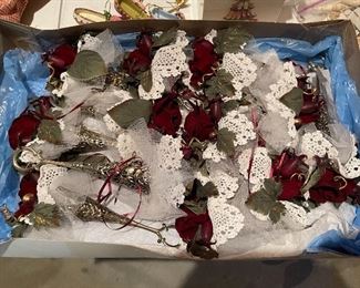 55. Table of christmas stuff including drum, stuffed stockings, bear, silverplate rose things, and more $60