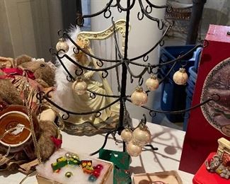 55. Table of christmas stuff including drum, stuffed stockings, bear, silverplate rose things, and more $60