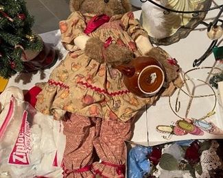 55. Table of christmas stuff including drum, stuffed stockings, bear, silverplate rose things, and more $60