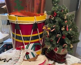 55. Table of christmas stuff including drum, stuffed stockings, bear, silverplate rose things, and more $60