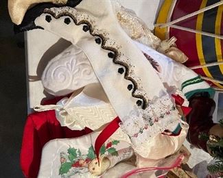 55. Table of christmas stuff including drum, stuffed stockings, bear, silverplate rose things, and more $60