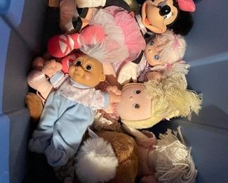 63. Dolls, dolls and some 1940s paper mache little individual guys. Also a Barbie Kaboodle and barbie card game and small wood blue dining set for a doll $50