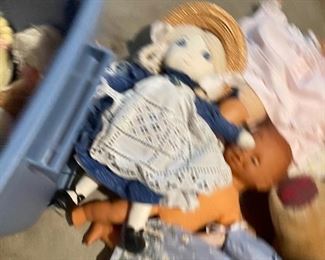 63. Dolls, dolls and some 1940s paper mache little individual guys. Also a Barbie Kaboodle and barbie card game and small wood blue dining set for a doll $50